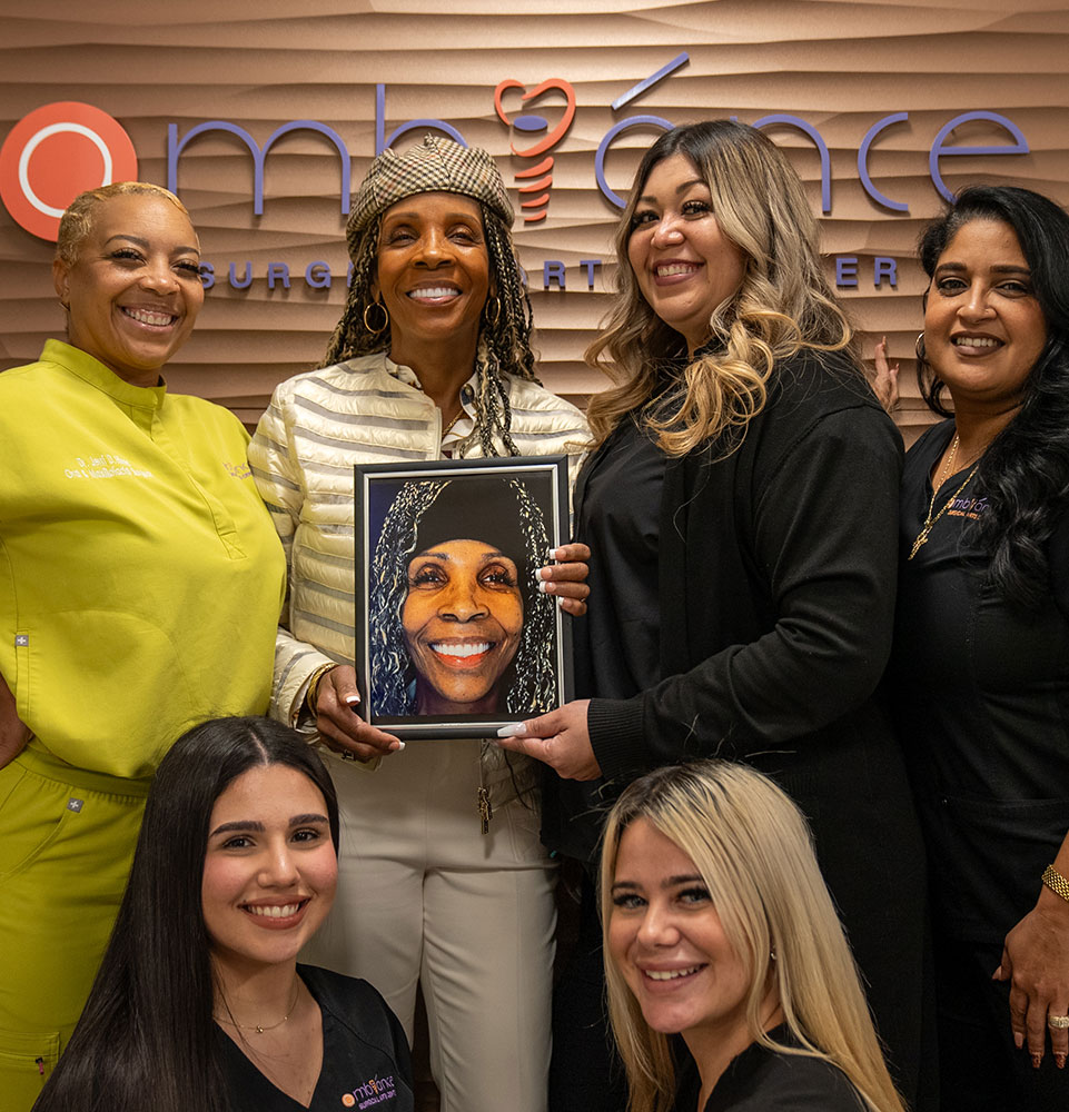 Jerri D. Hines DDS and team standing with patient smiling